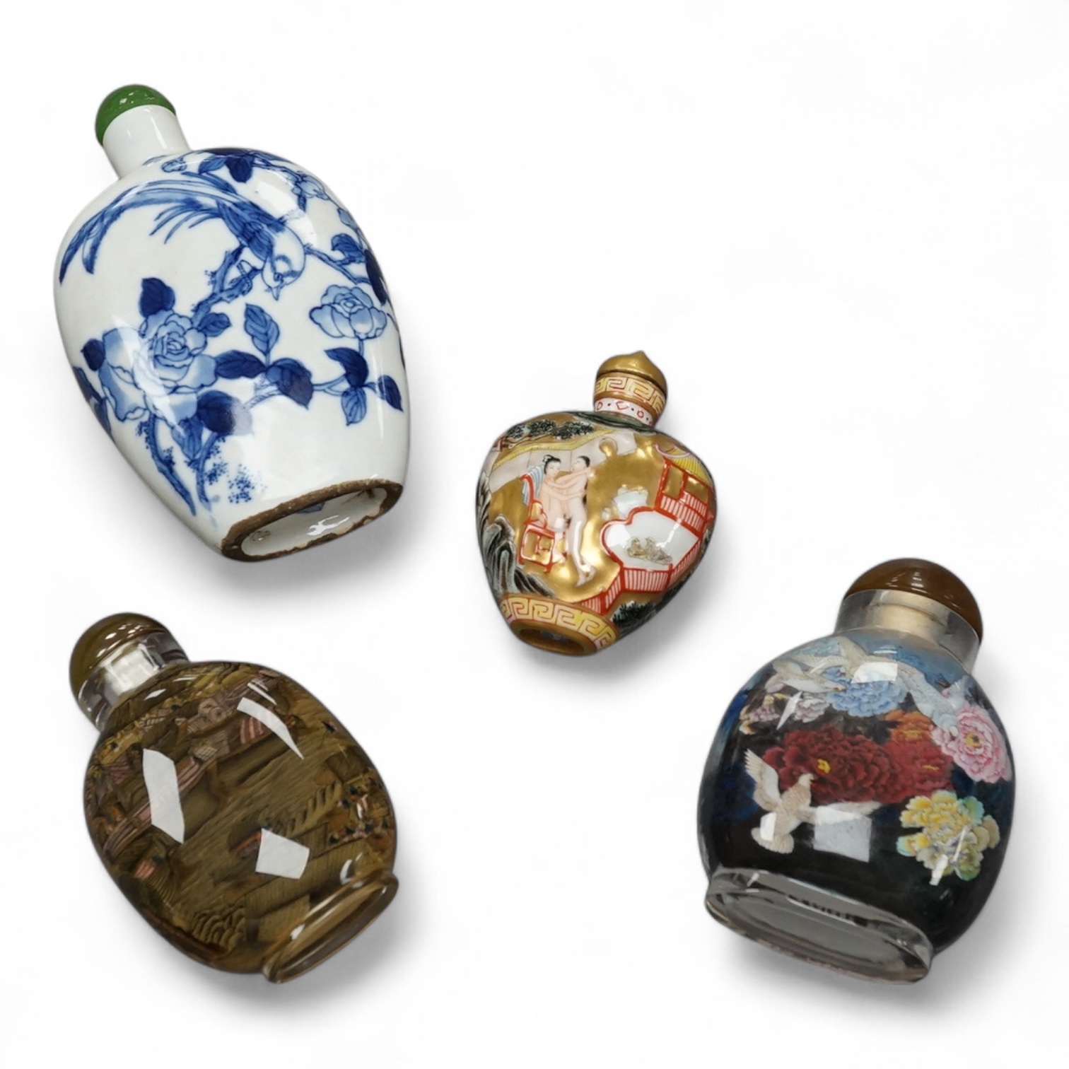 Two Chinese inside-painted glass snuff bottles and two porcelain snuff bottles, largest 12cm high. Condition - good